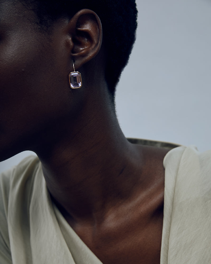 Photo of a model wearing fine earrings by Lizzie Fortunato