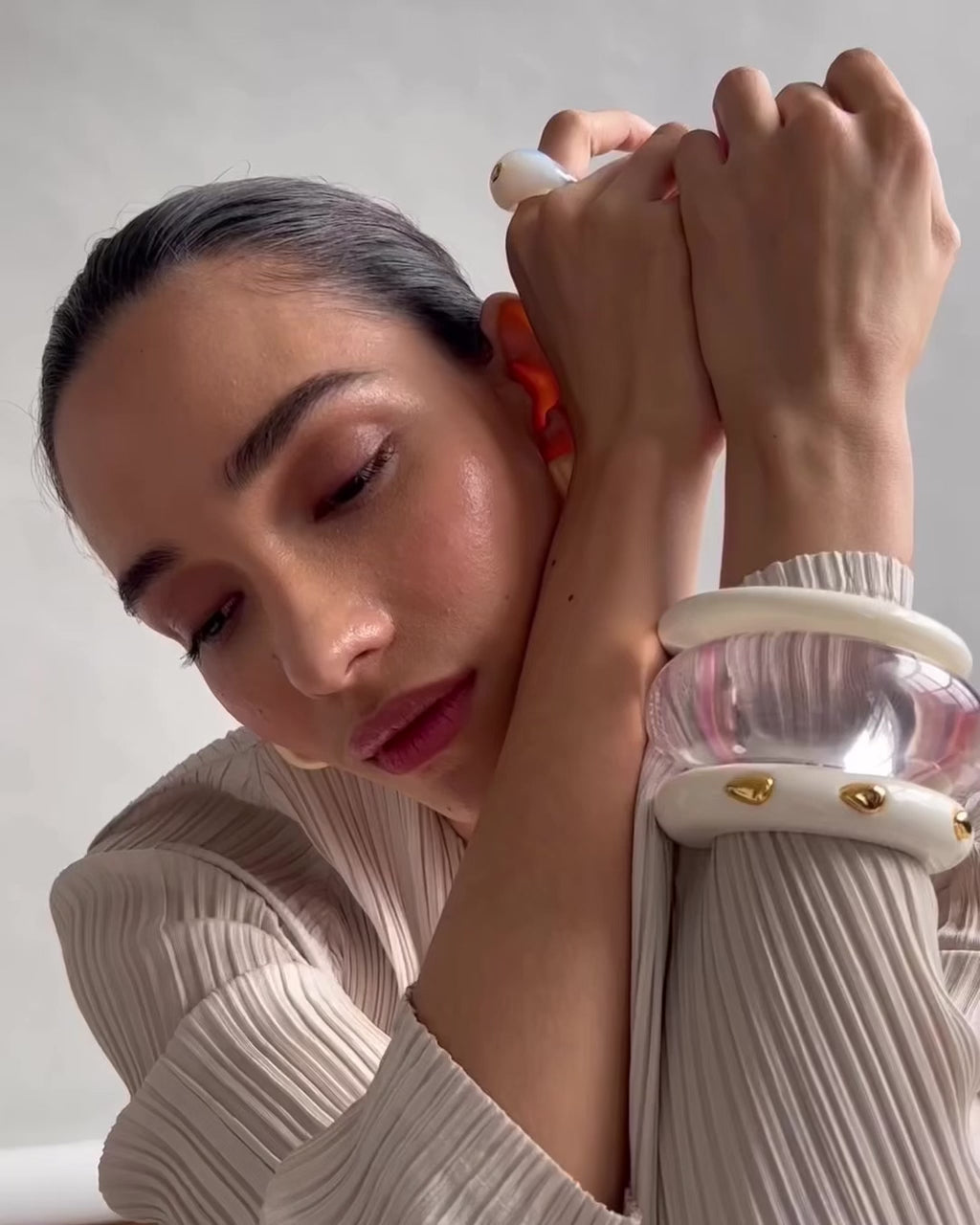 Video shows model wearing Ridge Cuff in Alabaster and Ridge Cuff in Alabaster and Gold Stud. 