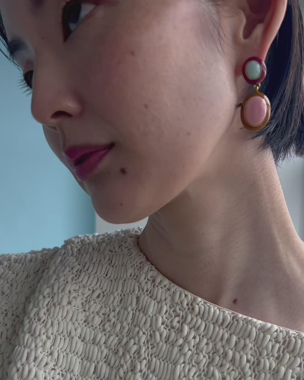 Video shows a close-up of Papaya Earrings In Pink Conch on the model.