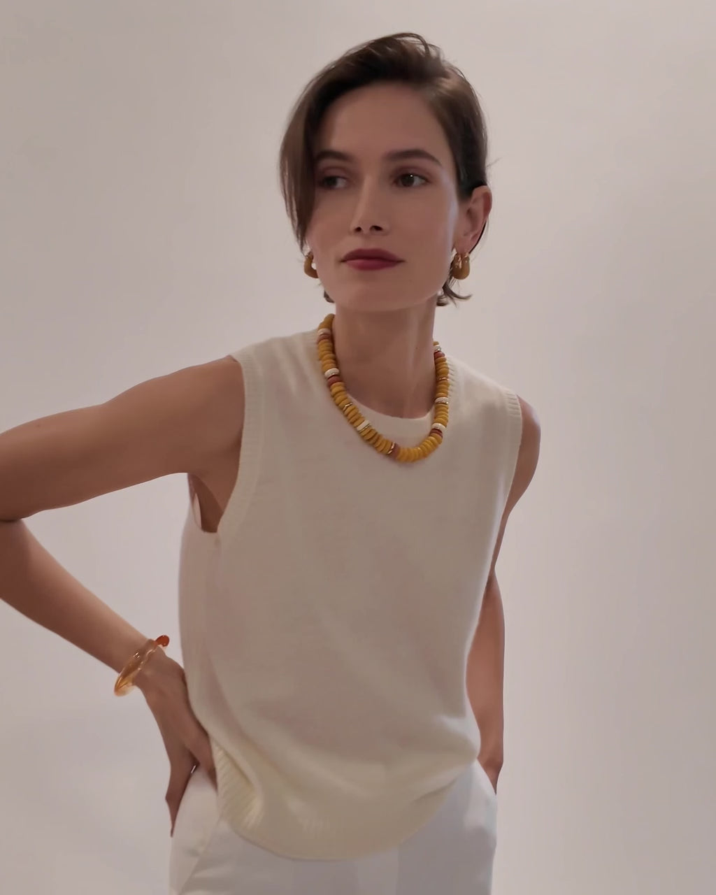 Video of model wearing white tank with Laguna Necklace in Mustard and Organic Hoops