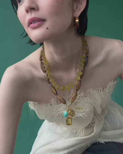 Close-up video of model wearing Mini Organic Hoops In Honey featured with Marilla Necklace and Canary Cliffs Necklace.