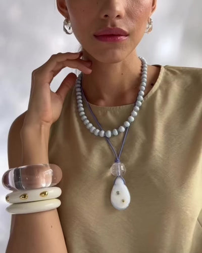 Video shows model wearing Matilde Cord Necklace styled with Seaside Cliffs Necklace and Lizzie Fortunato's cuffs.