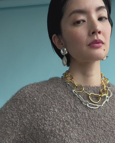 Close-up video of model wearing Rodan Pearl Earrings In Silver along with Porto Chain and Collage Chain Necklace In Silver