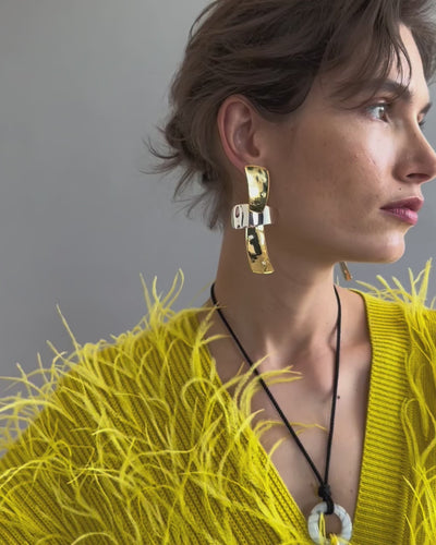 Video of model on grey backdrop in yellow feather top with Ernesto Earrings in Mixed Metal and Sun at Noon Necklace.