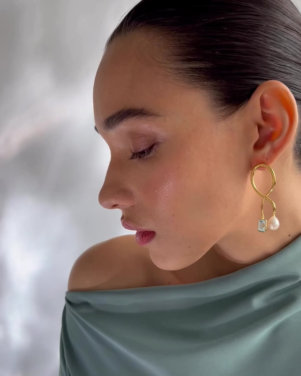 Video shows a close-up of model wearing Etienne Earrings. 