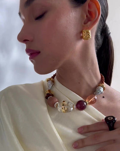 Video shows model wearing our Glass beach Necklace in Terra styled with Woven Hoops in Gold and Halo Ring In Root Beer. 