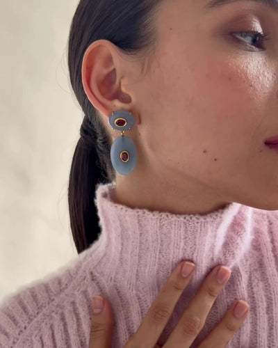 Video shows a close-up of model wearing Dorothy Earrings. 