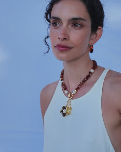 Video of model in white tank top with Mood Necklace in Amber and two hanging charms.