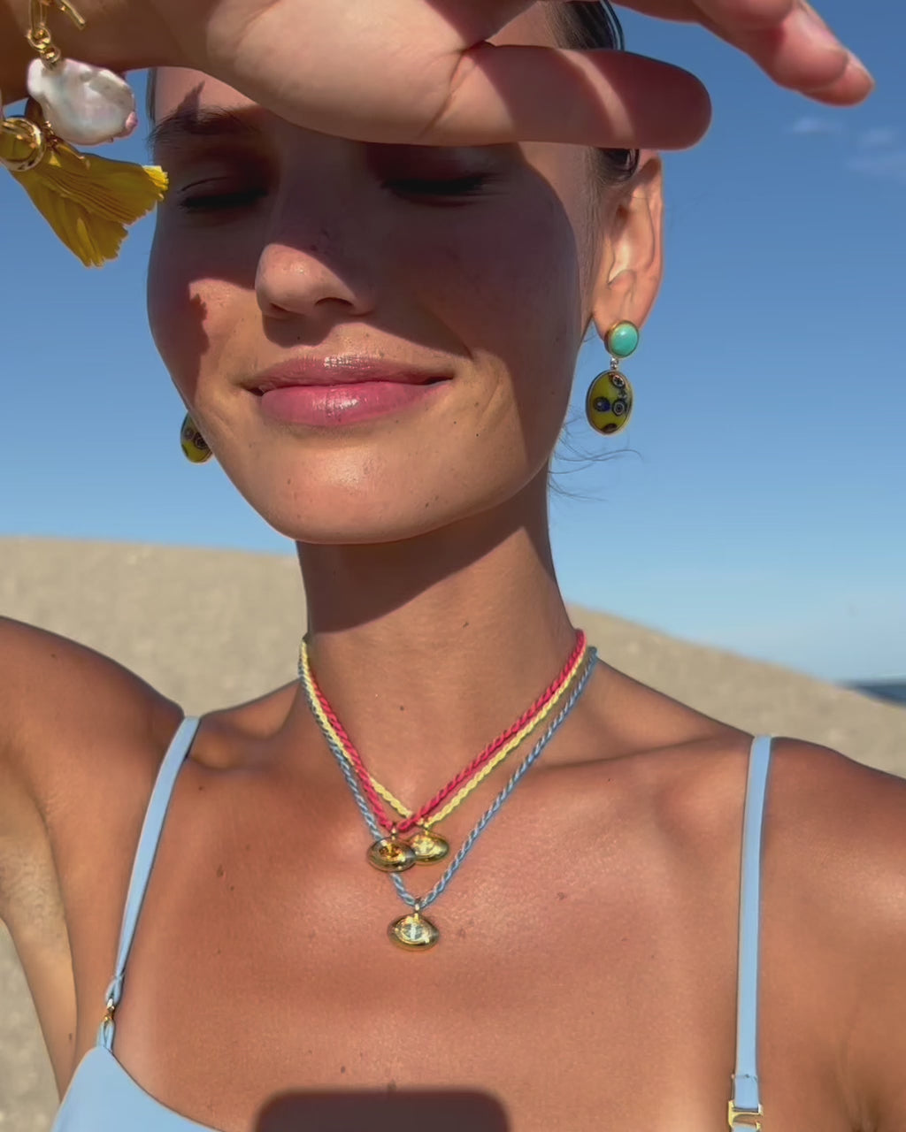 Video of model at beach wearing the Best Friend Necklaces with the Murano Muse Earrings and Shibori Ribbon Bracelets.