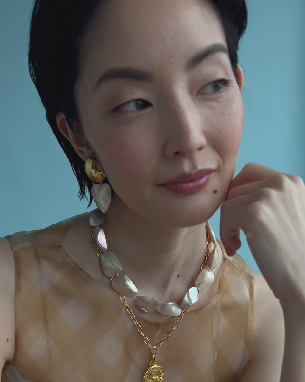 Close-up video featuring model with Pas De Deux Necklace and Rodan Heart Earrings