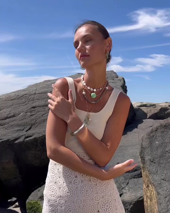 Video of model wearing Porto Covo Necklace in Azul, Organic Hoops, Treasure Heart Pendent and Mint Grotto Necklaces.