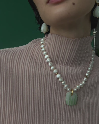 Close up video of Sean Bean Earrings and Marine Glass Necklace on model. 