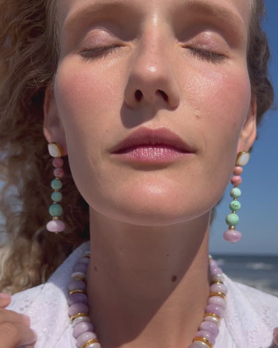 Video of model touching her neck while wearing Costa Nova Earings and Provence II Necklace.