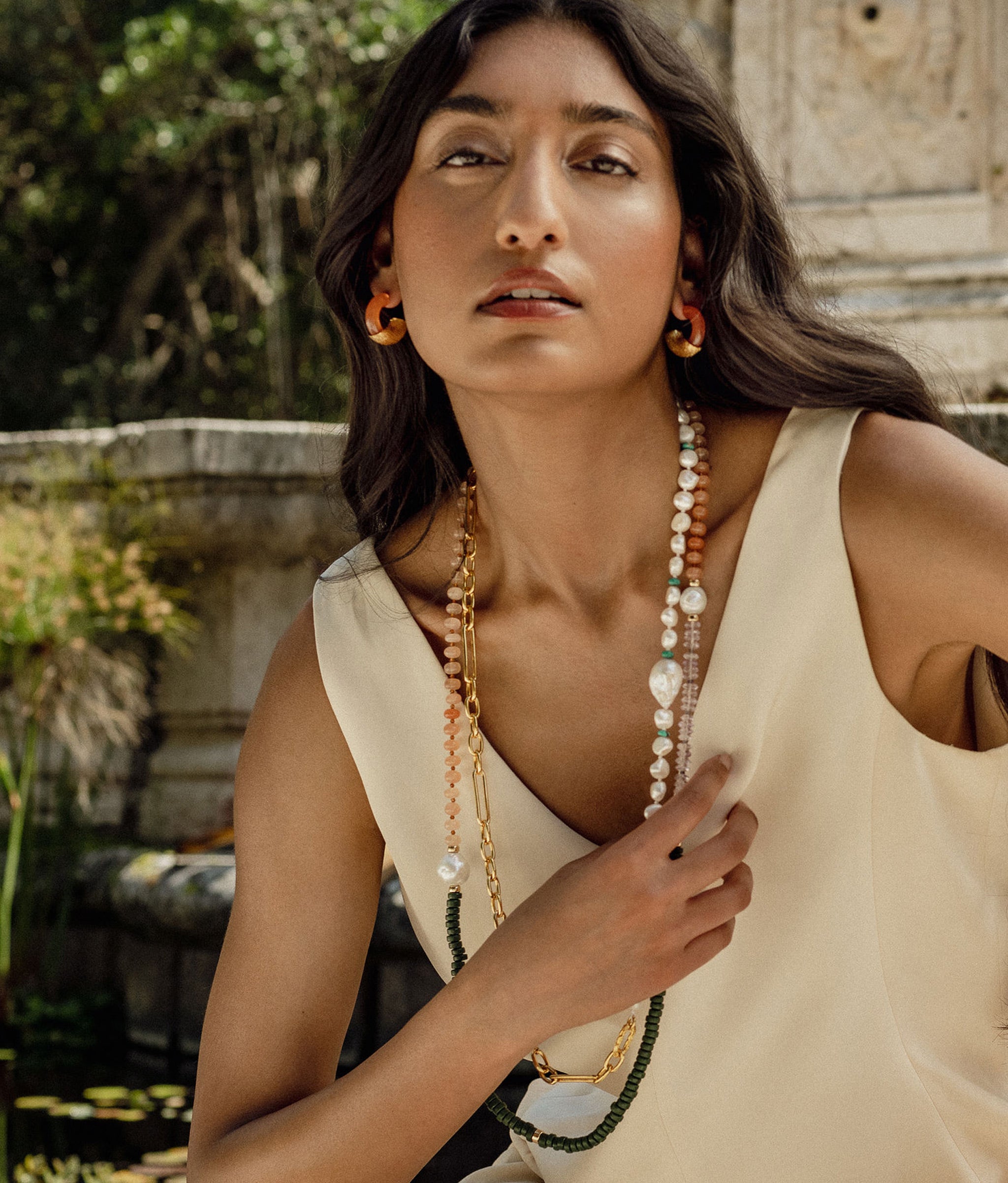 Model wearing the cabana necklace long with turquoise harbor necklace and etched infinity hoops.