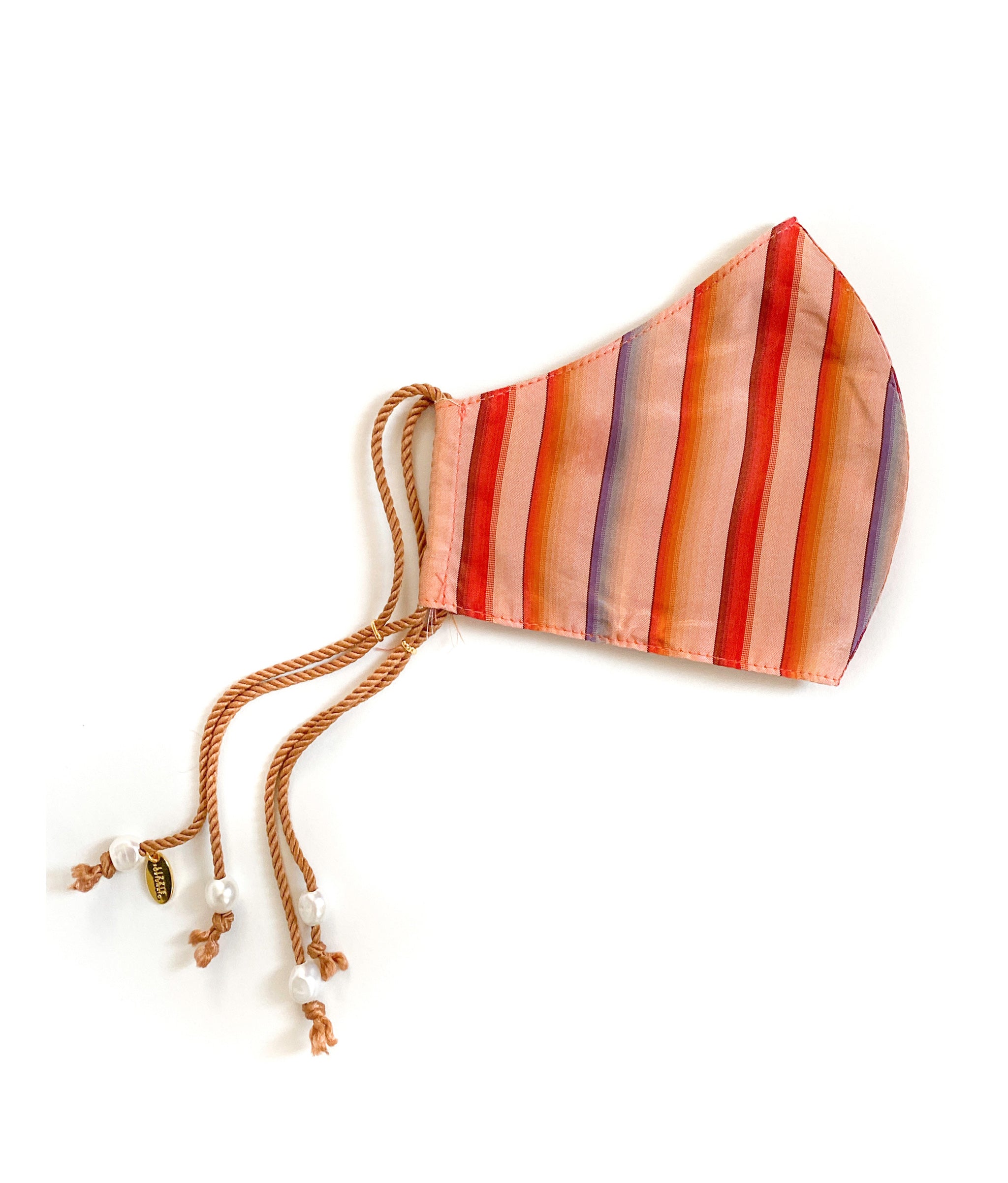 Side view of Face Mask in Golden Hour showing multicolor striped cotton with tan cord straps and freshwater pearl details.